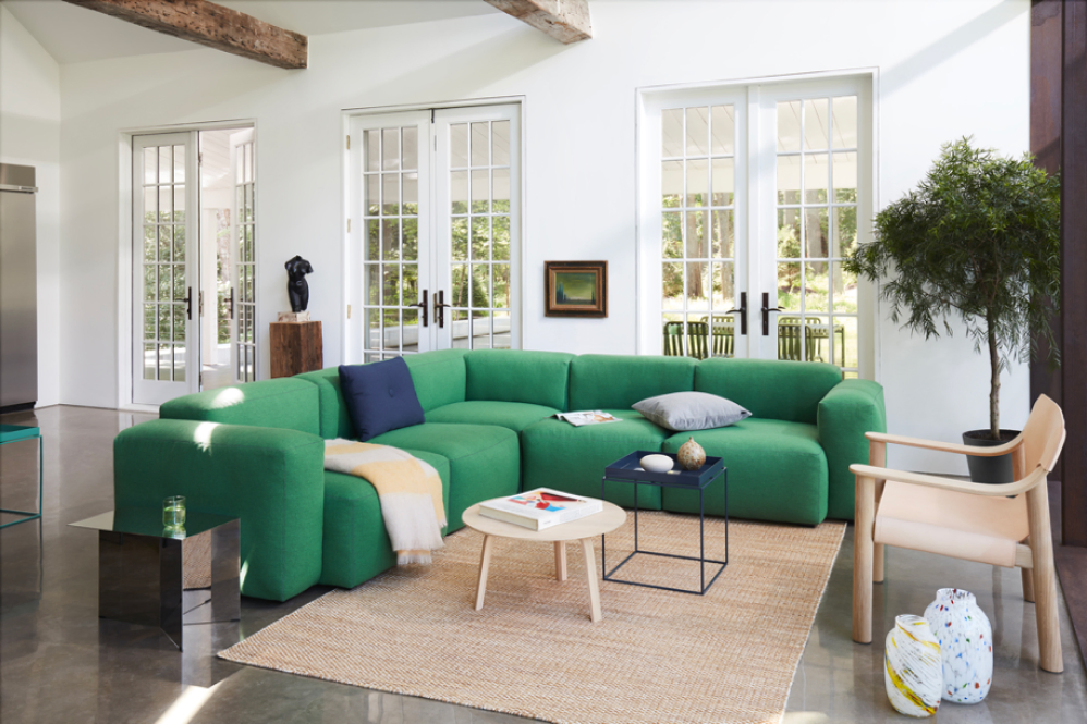 Helles Wohnzimmer mit grüner Sofalandschaft und Dekoration - seyfarth einrichtungen